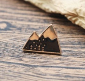Black and gold mountains camping themed Pin