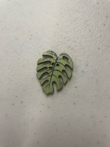 1 inch Shaped wooden button with 2holes. Faded Green Palm Leaf