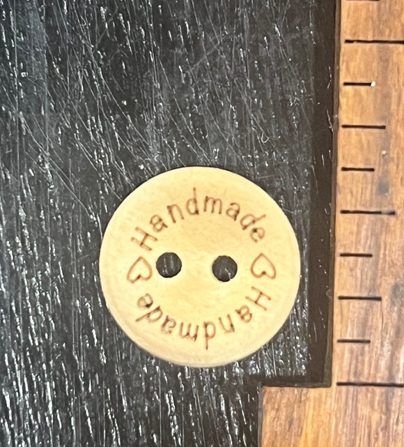 1/2 inch wooden button, two hole, ‘Handmade’ written twice