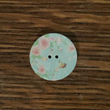 3/4 inch round, wooden, two hole button. White with printed picture.