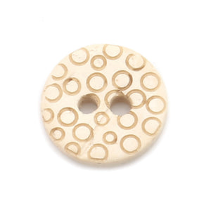Three-quarter inch round four hole button made of coconut shell