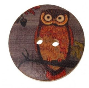 1 1/8 inch round wooden button with two holes. Feathering an owl #2