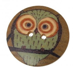 1 1/8 inch round wooden button with two holes. Feathering an owl #3